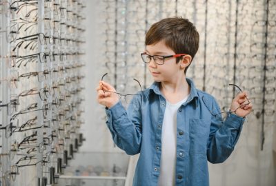 Boy,In,Glasses,,,At,Optics,Store.